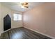 Bedroom featuring a ceiling fan, window and dark wood grain flooring at 499 Kristin Ln, Henderson, NV 89011