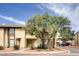 Two-story townhome featuring a neutral color scheme and xeriscaped landscaping under a partly cloudy blue sky at 499 Kristin Ln, Henderson, NV 89011