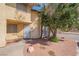 Inviting townhome showcasing tan stucco, a secure entrance, and drought-resistant landscaping at 499 Kristin Ln, Henderson, NV 89011