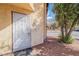 Secured front door with decorative bars, neutral desert landscaping and street view at 499 Kristin Ln, Henderson, NV 89011