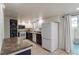 Charming kitchen with white cabinets, modern appliances, and a sliding glass door at 499 Kristin Ln, Henderson, NV 89011