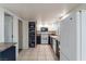 Open kitchen design featuring black and white cabinets, tiled floors, and decorative chalkboard at 499 Kristin Ln, Henderson, NV 89011
