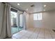 Bright living area with sliding glass doors to a patio and tiled flooring throughout at 499 Kristin Ln, Henderson, NV 89011