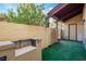 Cozy outdoor patio with greenery and a built-in grill area at 499 Kristin Ln, Henderson, NV 89011