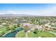 Picturesque aerial view of golf course community highlighting lush landscaping, water features, and homes at 5216 Desert Star Dr, Las Vegas, NV 89130