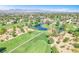 Beautiful aerial view of golf course community with lush landscaping, water features, and mountain views at 5216 Desert Star Dr, Las Vegas, NV 89130