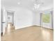 Bright, airy bedroom with light wood floors, neutral walls, and a ceiling fan at 5216 Desert Star Dr, Las Vegas, NV 89130