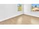 Light-filled bedroom with wooden floors, two bright windows and neutral walls at 5216 Desert Star Dr, Las Vegas, NV 89130