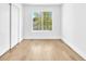 Clean bedroom with light-colored wooden floors, a window and closet with sliding doors at 5216 Desert Star Dr, Las Vegas, NV 89130