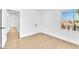 Inviting bedroom with light wood flooring, a view into the hallway and neutral walls at 5216 Desert Star Dr, Las Vegas, NV 89130