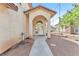 Covered front entrance with double glass doors and a concrete walkway at 5216 Desert Star Dr, Las Vegas, NV 89130