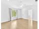 Spacious main bedroom featuring hardwood floors, a ceiling fan and a view to the backyard at 5216 Desert Star Dr, Las Vegas, NV 89130