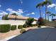 Backyard area with a concrete patio, rock features, and mature palm trees with clear blue sky at 5376 S Conquistador St, Las Vegas, NV 89148