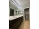 Bathroom with double sinks, vanity and view into adjacent toilet room at 5376 S Conquistador St, Las Vegas, NV 89148