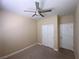 This bedroom features a ceiling fan, closet, and a door leading to another room at 5376 S Conquistador St, Las Vegas, NV 89148