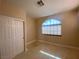 Bright bedroom with a large arched window, neutral walls and tiled floors at 5376 S Conquistador St, Las Vegas, NV 89148