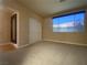 Carpeted bedroom featuring a window, closet with sliding doors, and an adjacent hallway at 5376 S Conquistador St, Las Vegas, NV 89148