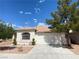 Charming single-story home featuring a tile roof, arched window, and a well-maintained two-car garage at 5376 S Conquistador St, Las Vegas, NV 89148