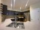 Stylish kitchen boasts stainless steel appliances, sleek countertops, and modern cabinetry with matching backsplash at 5376 S Conquistador St, Las Vegas, NV 89148