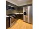 Stylish kitchen boasts stainless steel appliances, sleek countertops, and modern cabinetry with matching backsplash at 5376 S Conquistador St, Las Vegas, NV 89148