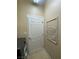 Functional laundry space featuring a white door and wall-mounted drying rack, next to modern washer and dryer units at 5376 S Conquistador St, Las Vegas, NV 89148