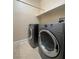 Well-equipped laundry area with modern washer and dryer, complemented by convenient shelving for storage at 5376 S Conquistador St, Las Vegas, NV 89148