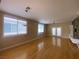 Open-concept living room with hardwood floors, large windows, and a modern decorative stone panel wall at 5376 S Conquistador St, Las Vegas, NV 89148