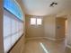 Neutral living room featuring tile floors, arched window and an abundance of natural light at 5376 S Conquistador St, Las Vegas, NV 89148