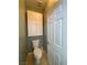 Powder room featuring tile flooring, a toilet, and a cabinet for storage at 5376 S Conquistador St, Las Vegas, NV 89148