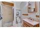 A modest bathroom offers a toilet, sink, mirror, and shower with glass doors at 557 6Th St, Boulder City, NV 89005