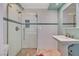 Updated bathroom featuring a glass-enclosed shower, a pedestal sink, and tiled floor at 557 6Th St, Boulder City, NV 89005