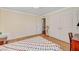 Bedroom featuring hardwood floors, a patchwork quilt, double closets, and a large window at 557 6Th St, Boulder City, NV 89005