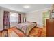 Cozy bedroom with hardwood floors, a patterned rug, and a view of an ensuite bathroom at 557 6Th St, Boulder City, NV 89005