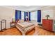 Comfortable bedroom with hardwood floors, a patterned rug, and a dark wood dresser at 557 6Th St, Boulder City, NV 89005
