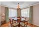 A formal dining area featuring a hardwood table set with six chairs and soft, natural lighting at 557 6Th St, Boulder City, NV 89005