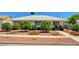 Charming single-story home featuring well-maintained landscaping with mature trees and plants in the front yard at 557 6Th St, Boulder City, NV 89005