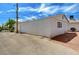 Exterior side view of the white house with a window, garage and backyard at 557 6Th St, Boulder City, NV 89005