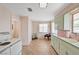 Bright kitchen with tile floors, light pink walls, and vintage appliances at 557 6Th St, Boulder City, NV 89005