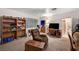 A cozy living room features a recliner, shelving, and doorway to the bathroom at 557 6Th St, Boulder City, NV 89005