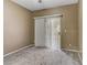 Bedroom featuring sliding glass door, plush carpet and vertical blinds at 5655 E Sahara Ave # 1052, Las Vegas, NV 89142