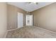 This bedroom features neutral carpeting, a ceiling fan, and access to an ensuite bathroom at 5655 E Sahara Ave # 1052, Las Vegas, NV 89142