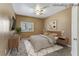 This staged bedroom offers a ceiling fan and a comfy-looking bed at 5655 E Sahara Ave # 1052, Las Vegas, NV 89142
