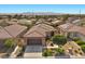 This aerial view showcases a well-maintained home with a desert landscape and mountain views at 5745 Sagamore Canyon St, North Las Vegas, NV 89081