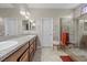 Bright bathroom with double sinks, large mirror, and glass enclosed shower at 5745 Sagamore Canyon St, North Las Vegas, NV 89081
