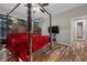 Spacious bedroom with four-poster bed, ceiling fan, and wood-look flooring at 5745 Sagamore Canyon St, North Las Vegas, NV 89081