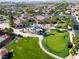 Stunning aerial view of the community clubhouse featuring a sparkling pool and manicured putting green at 5745 Sagamore Canyon St, North Las Vegas, NV 89081