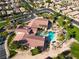This aerial view highlights the community clubhouse, pool, and surrounding lush green spaces at 5745 Sagamore Canyon St, North Las Vegas, NV 89081