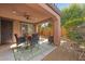 Relax in this charming covered patio with comfortable seating and a view of the landscaped backyard at 5745 Sagamore Canyon St, North Las Vegas, NV 89081