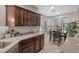 Charming kitchen with granite countertops, dark wood cabinets, and stainless steel sink at 5745 Sagamore Canyon St, North Las Vegas, NV 89081