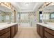 Bathroom boasts dual vanities, a separate shower, and a soaking tub with natural light at 5747 Jaborandi Ave, Pahrump, NV 89061